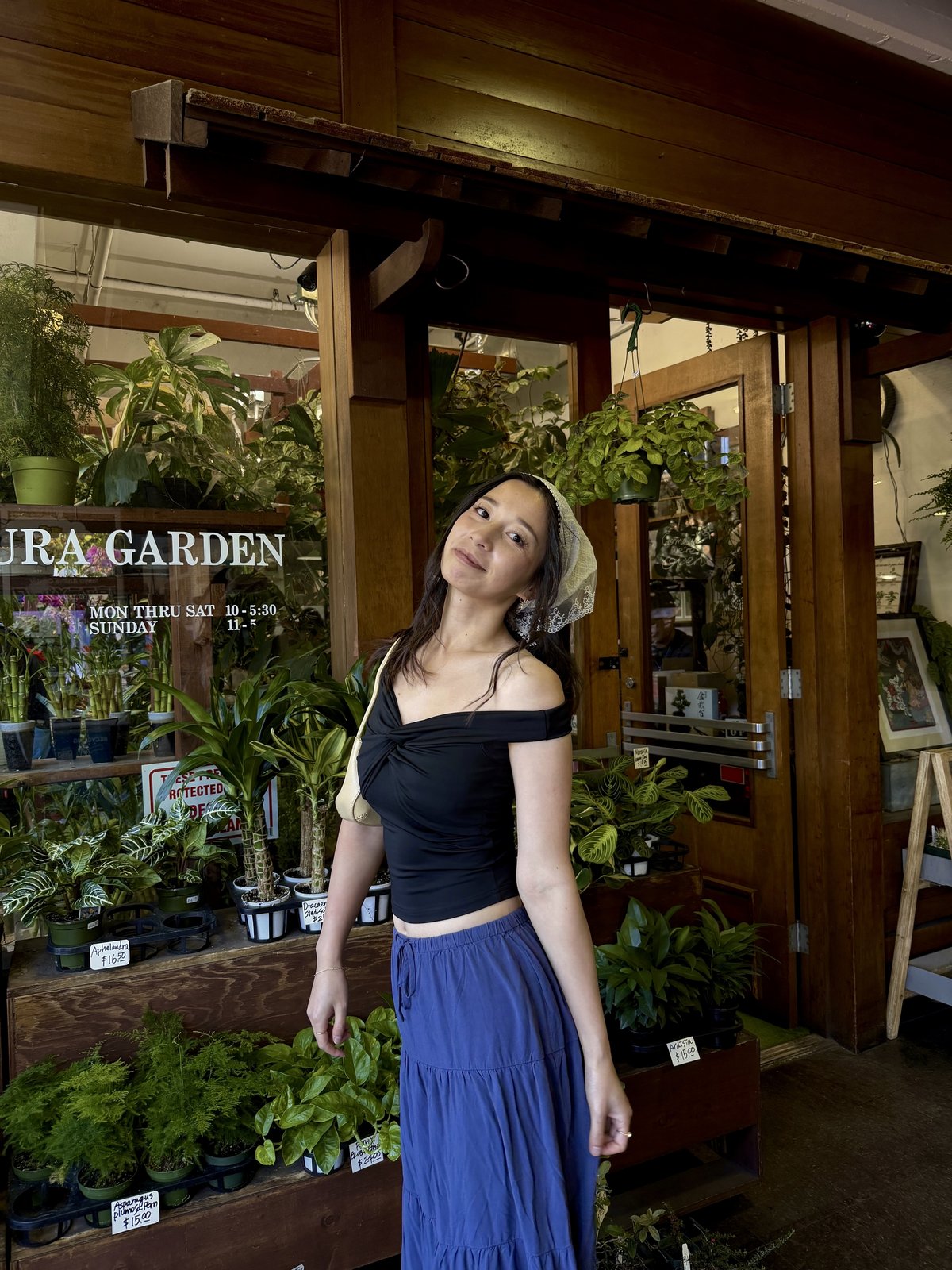Connie in front of a garden shop